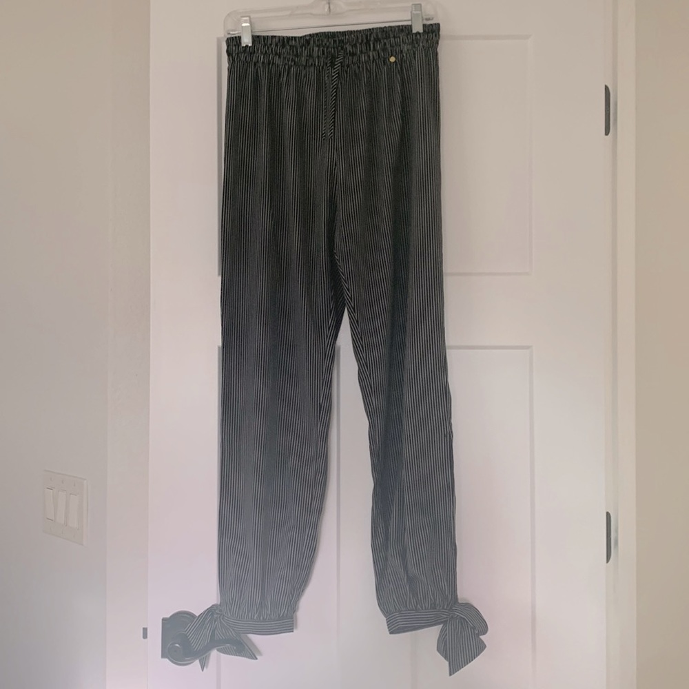 Slim cut pants with slit on each side that runs mid calf to ankle